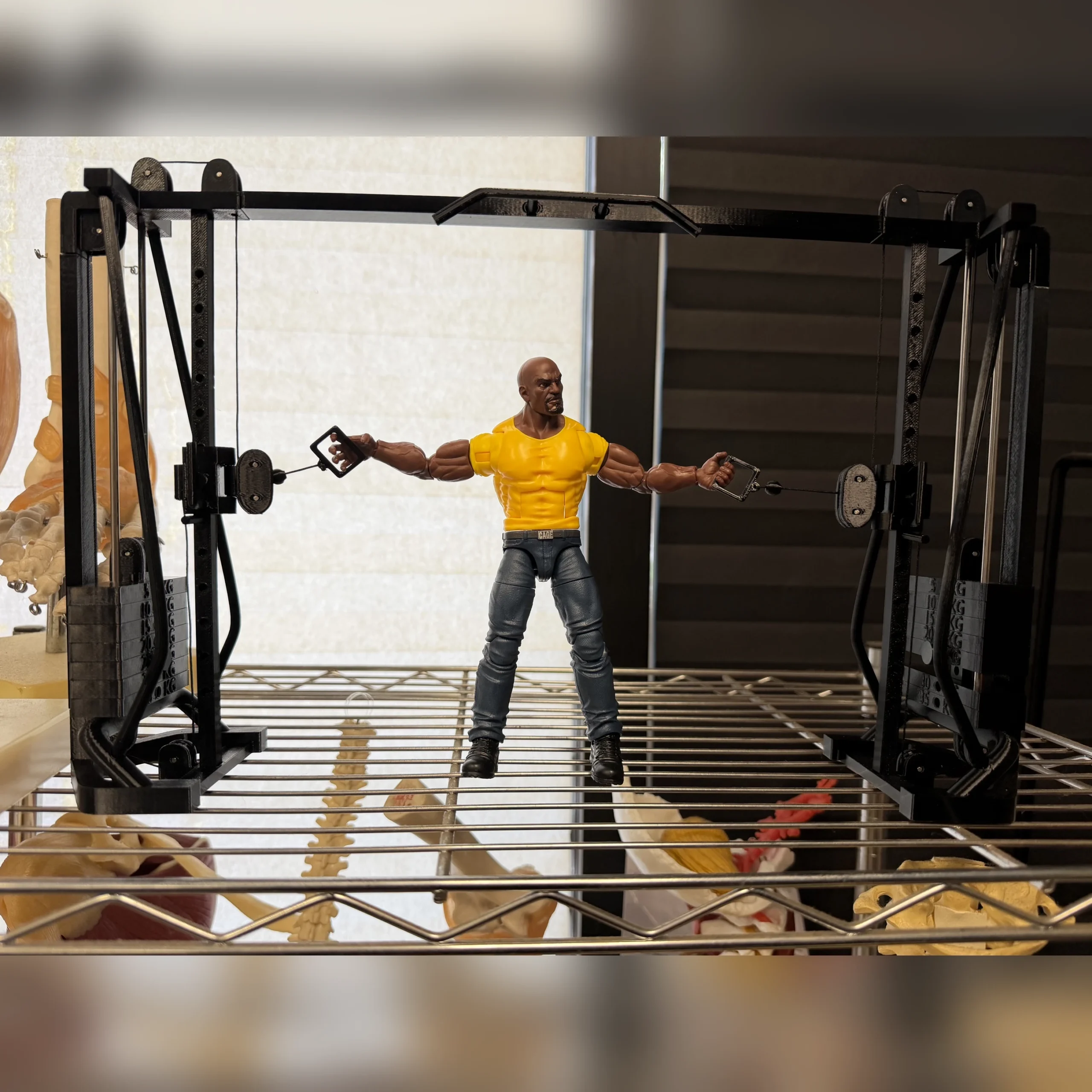 Customer action figure posed between the handles of a miniature cable crossover on a shelf